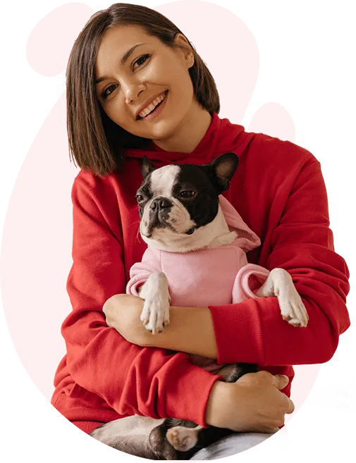 A smiling woman hugging her rescued dog
