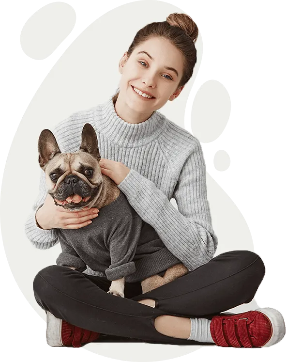 A girl hugging her French bulldog
