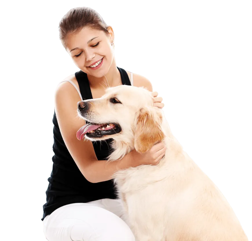 A woman smiling with her golden retriever